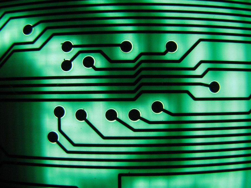 Close-up of copper traces on a green printed circuit board