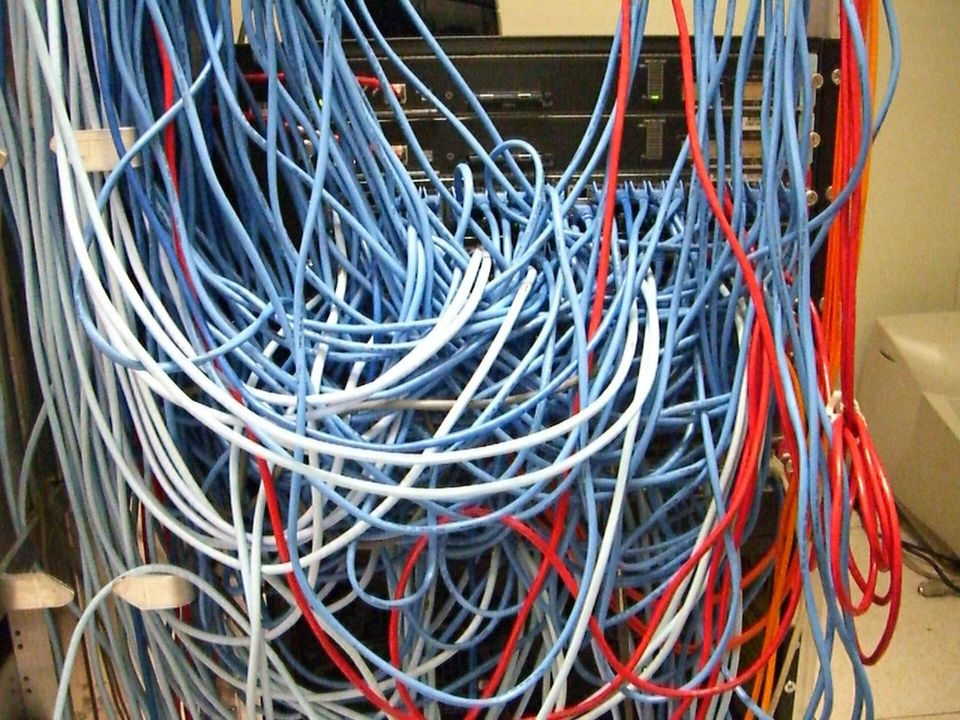 Dense bundle of network cables running into a server rack