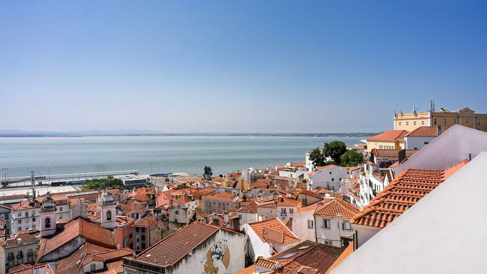 Terracotta rooftops of the Alfama district running down to the river
