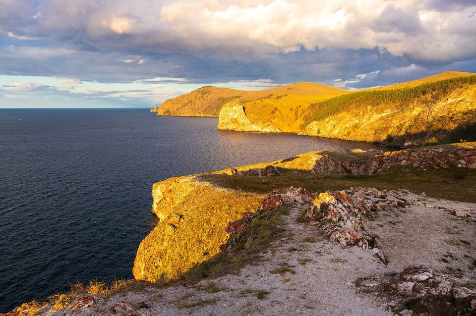 Golden evening light over a rugged coastline and the sea
