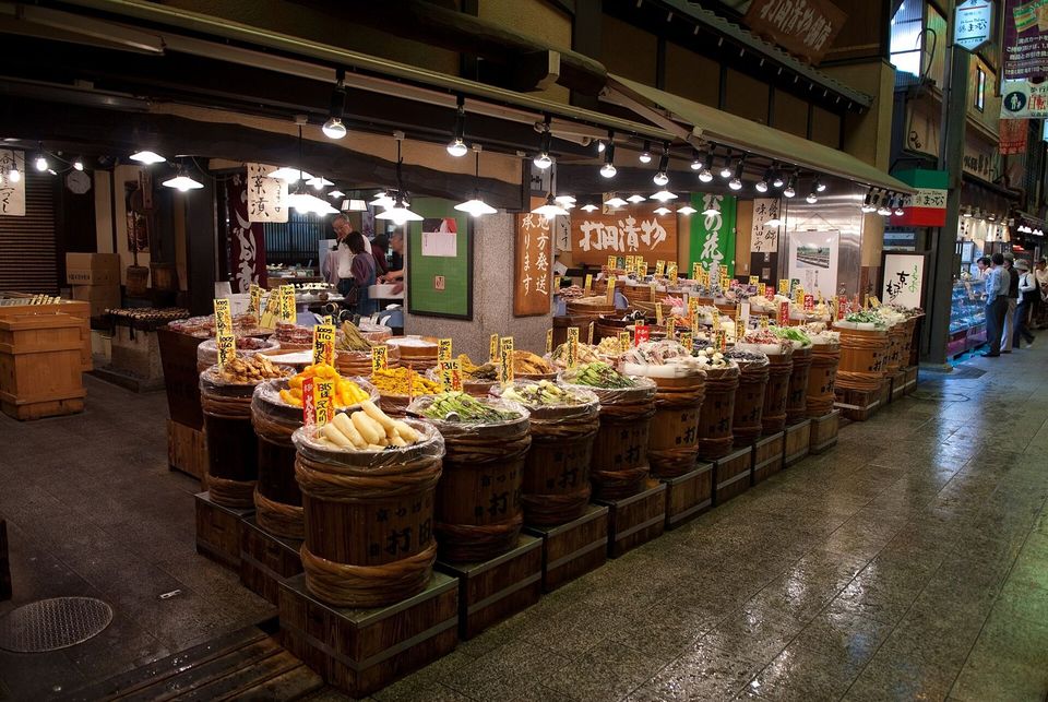 Food stalls with colourful produce under the roof of Nishiki Market