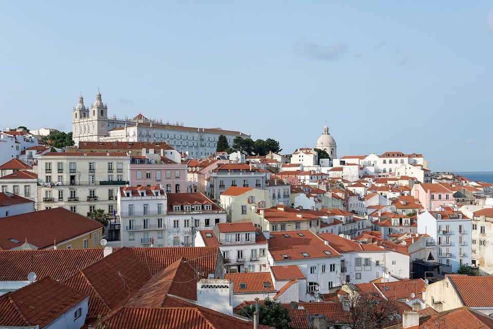 View over Lisbon rooftops and church domes towards the Tagus