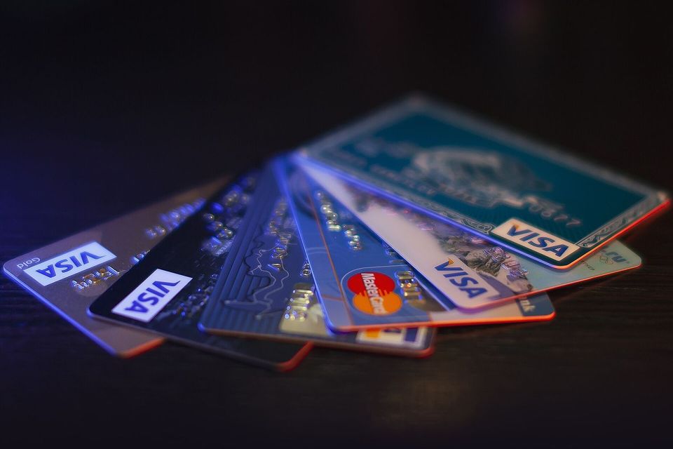A fan of credit cards on a dark surface