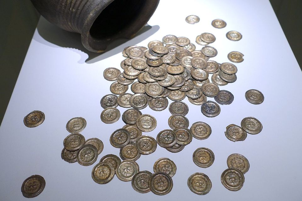 A pile of coins on a white table
