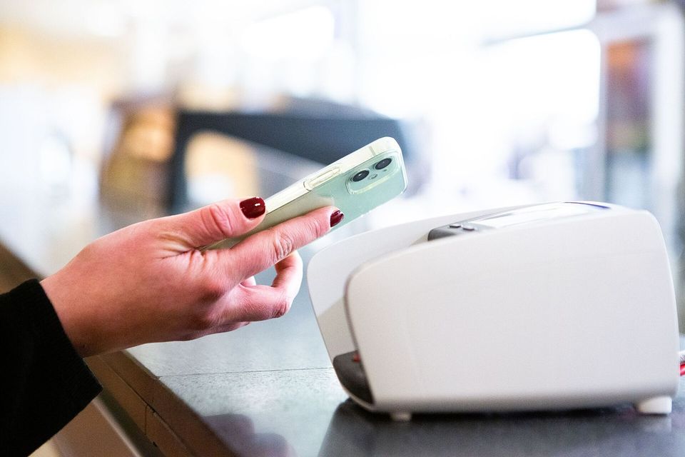 Person paying with a contactless card at a card terminal